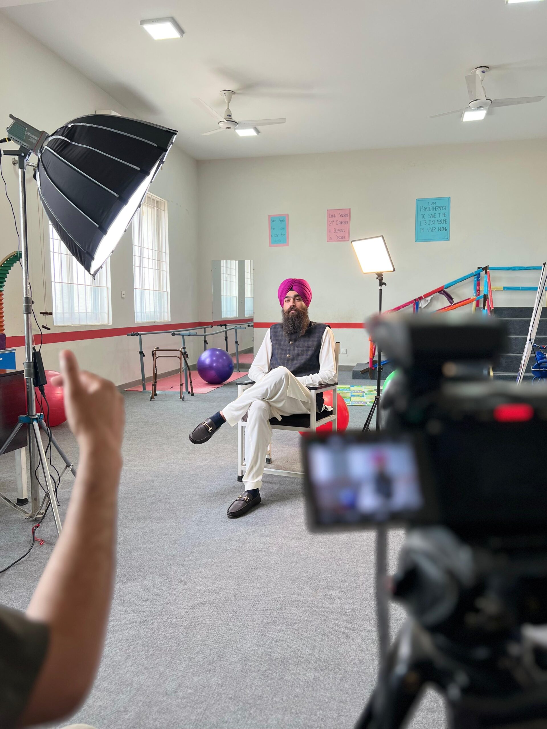 Man sitting on a chair being filmed during a call-to-action video shoot